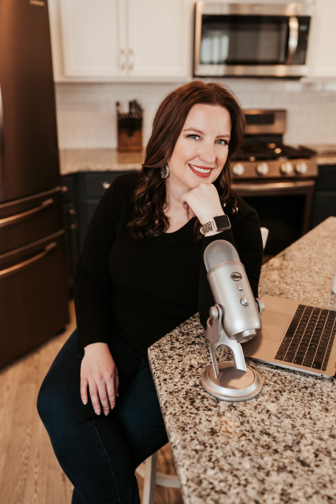 Monica Froese sitting at counter podcasting