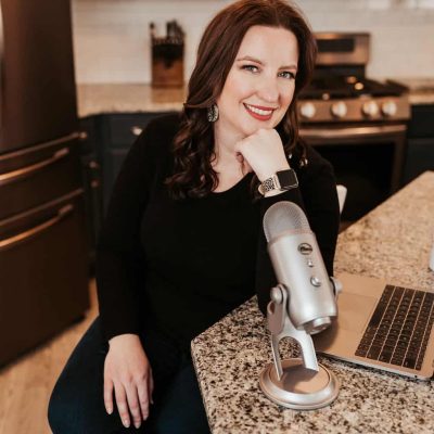 Monica Froese sitting at counter podcasting